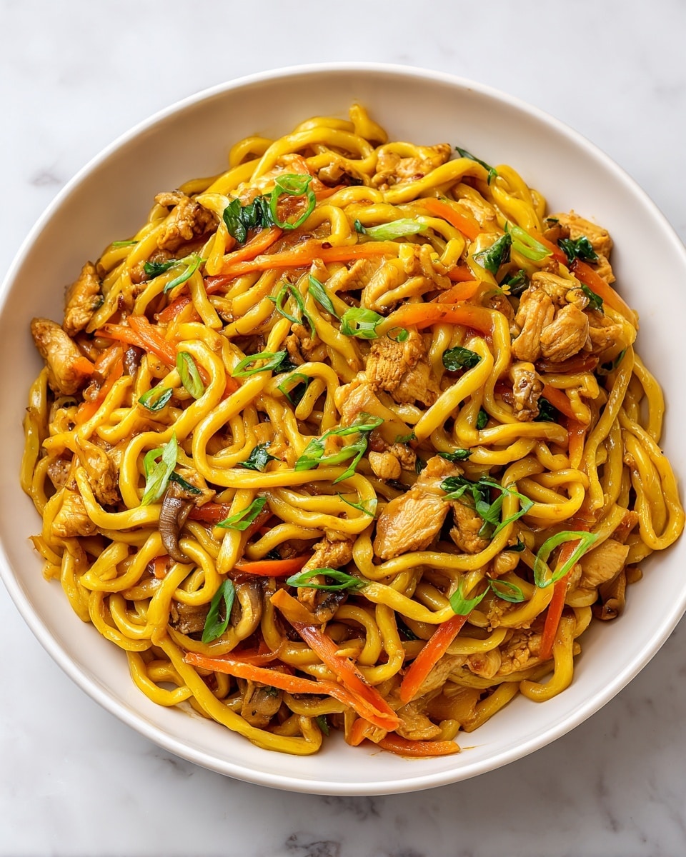 A close-up view of a bowl filled with stir-fried thick yellow noodles mixed with browned pieces of chicken and slices of mushrooms. There are thin strips of orange carrot and translucent cooked onion tucked between the noodles. Fresh green onions, both light and dark green parts, are sprinkled on top, adding a fresh, vibrant color. The bowl is white with a slight brown rim and placed on a white marbled surface. The textures show glossy noodles and tender, juicy chicken pieces with a slight char. photo taken with an iphone --ar 4:5 --v 7