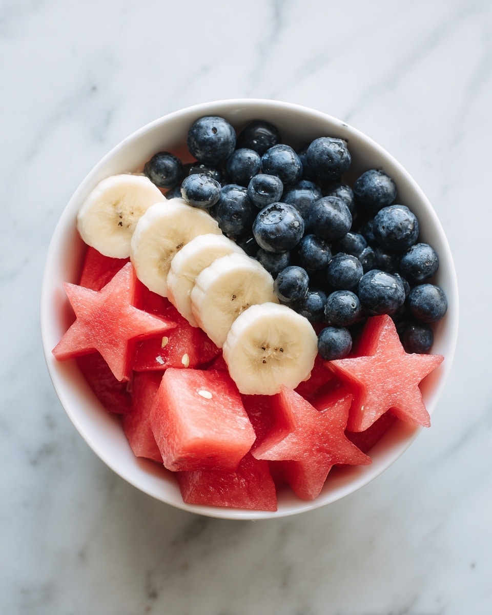 A white bowl filled with three layers of fresh fruit on a white marbled surface. The bottom layer has red star-shaped slices of watermelon covering the bowl evenly. On top of the watermelon, there are many round blue blueberries scattered all over. On one side of the bowl, there are layers of round yellow banana slices stacked neatly, with blueberries placed on and around them. The colors are bright and vivid, showing fresh and juicy textures. photo taken with an iphone --ar 4:5 --v 7