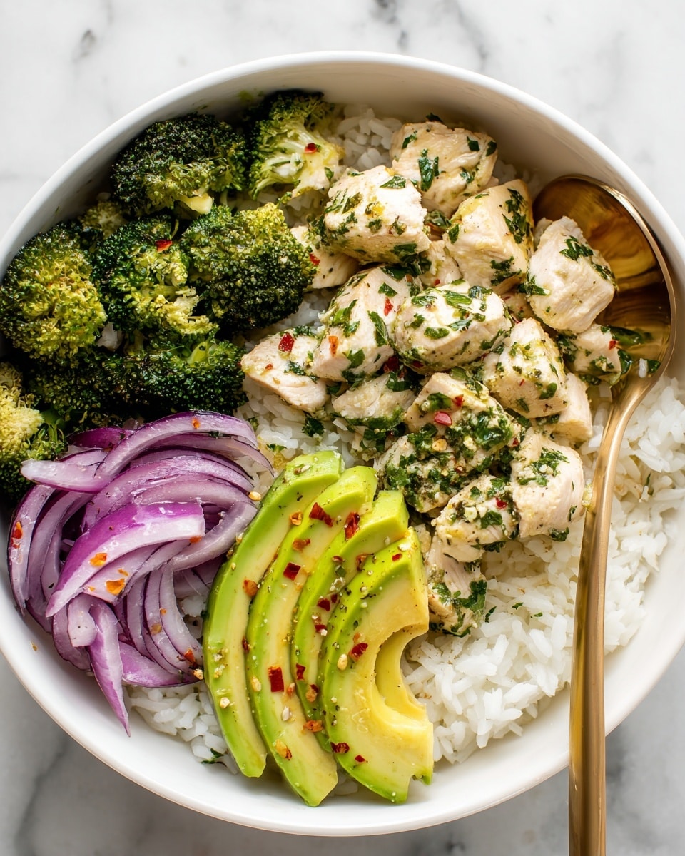 A white bowl filled with a base layer of white rice topped with bright green steamed broccoli pieces. Above the broccoli, there are bite-sized pieces of cooked light-colored chicken scattered evenly. Thin rings of purple-red onion are layered on top, adding a pop of color. On one side of the bowl, there are several slices of fresh green avocado arranged in a fan shape. The dish is sprinkled with small red chili flakes and finely chopped fresh herbs, giving it a fresh and spicy look. A golden spoon rests inside the bowl, and the bowl is placed on a white marbled surface. Photo taken with an iphone --ar 4:5 --v 7